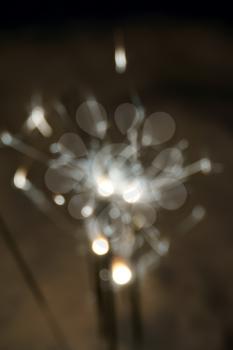 Blurred christmas sparkler, bengal fire and snow background.                               