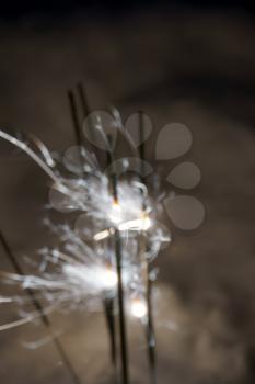 Blurred christmas sparkler, bengal fire and snow background.                               