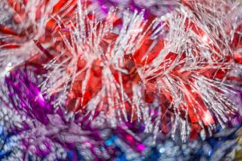 Colored decorative Christmas tinsel texture as holiday background.