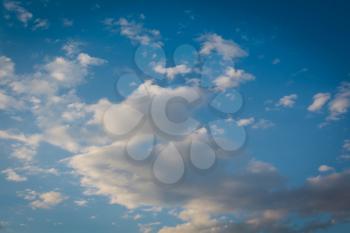 Blue sky with soft dark clouds, natural background.