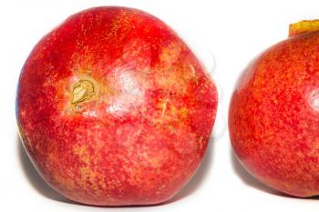 Fresh ripe raw fruit, whole red pomegranate on white background.