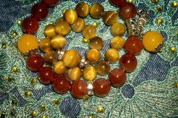 Boho beaded bracelets with red and brown stones.