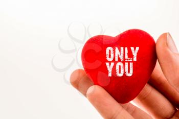 heart shape object in hand with only you inscription