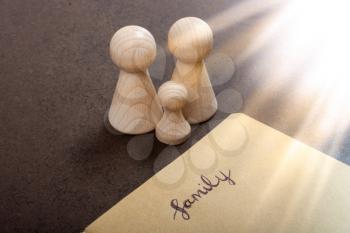 Notebook with family wording and wooden figurines  as family concept