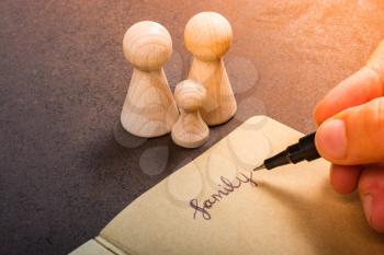 Wooden figurines of  family as concept of caring for children