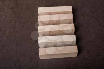 Wooden piece of domino wood on dark background