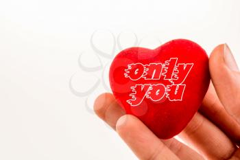 heart shape object in hand with only you inscription