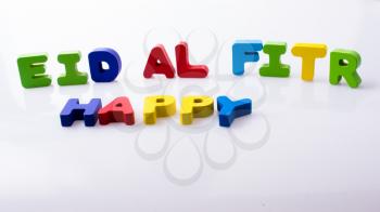 the word EID EL FITR  written with colorful letter blocks