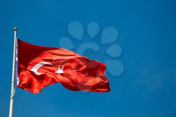 Turkish national flag with white star and moon in sky