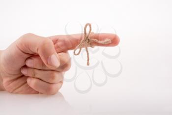 Hand tied with a thread like a ribbon on a white background