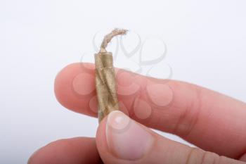 Gold colorl candle stick in hand on a white background