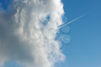 Airplane smoke trail and cloud. Abstract background.