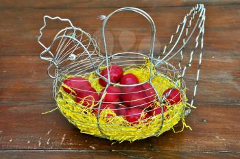 Vintage chicken shaped basket with red painted easter eggs.