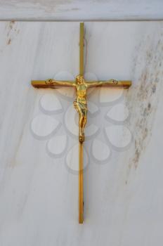 Golden crucifix on marble background. Jesus Christ on the cross religious symbol.