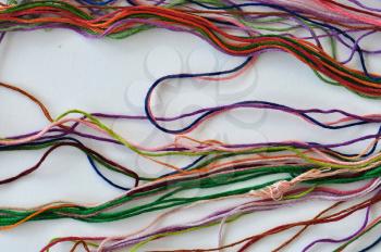 Colorful sewing threads on white background.