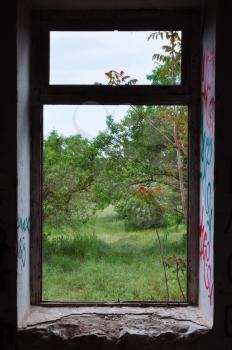 Abandoned house window frame with view to nature scene. Abstract landscape.