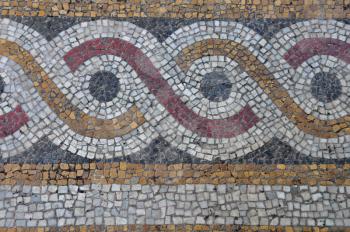 Floor mosaic background with circles pattern abstract geometric design on byzantine era church exterior.