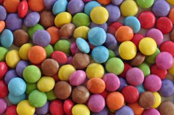 Colorful candy pieces abstract background. Chocolate dessert.
