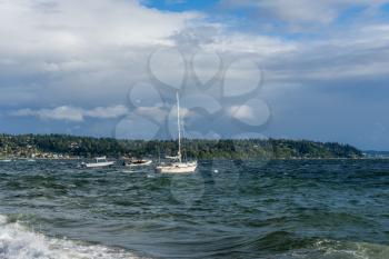 Boats are anchored at Three Tree Point in Burien, Washington on a windy day.