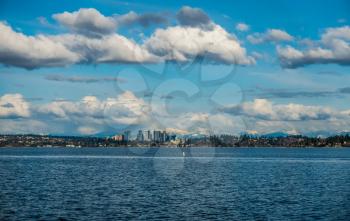 A view of the skyline of Bellevue, Washington with the Cascade Mountains behind.