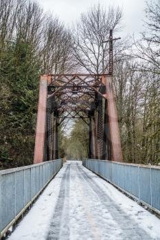 Snow covers a bridge and trestle that spans the Cedar River in Renton, Washington.