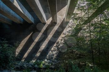 Support structure casts shadows onto a wall at the Des Moines Creek Trail in Washington State.