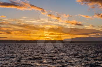 A view of a golden sunset across the Puget Sound from West Seattle, Washington.