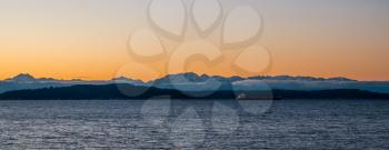 A silhouette of the Olympic Mountains at sunset.  Panoramic shot.
