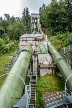 Green pipes rise up at a power station in Snoqualmie, Washington.