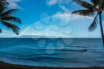 A view of a rainbow over the ocean in Maui, Hawaii.