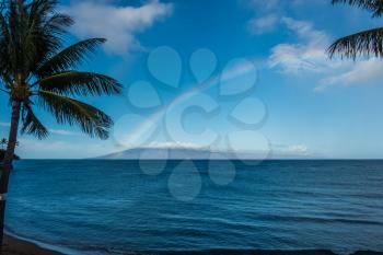 A view of a rainbow over the ocean in Maui, Hawaii.