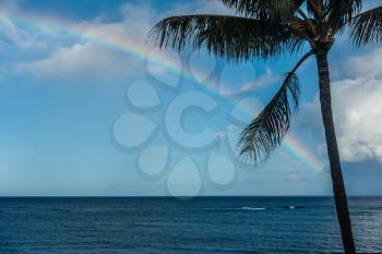 A view of a rainbow over the ocean in Maui, Hawaii.