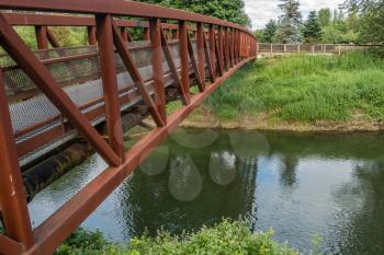 A rusted metal bridge spans the Green River in Kent, Washington.