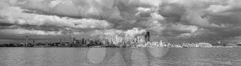 A view of the Seattle skyline across Elliott Bay. Black And white image.