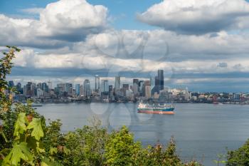 A ship sits in front of the Seattle skyline.