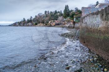 A veow of a seawall and buildings along the shore in West Seattle, Washington.