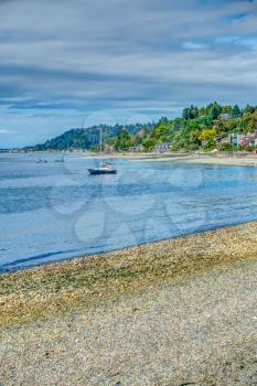 A boat is moored in front of residences in Wast Seattle, Washington. HDR image.