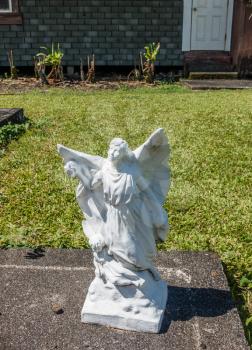 A statue of an angel sits in a cemetary on Maui, Hawaii.