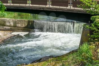 A view of Tumwater Falls and a wooden walking bridge.
