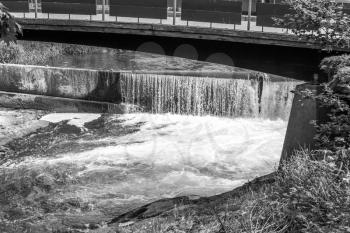 A view of Tumwater Falls and a wooden walking bridge.