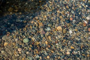 A view of pebbles on the shore at Seahurst Park in Burien, Washington.