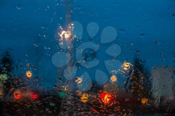 A veiw through a wet car windshield in the Pacific Northwest.