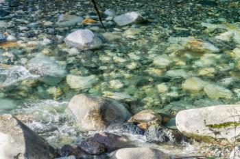 Clear water flows over rocks in Denny Creek in Washington State.