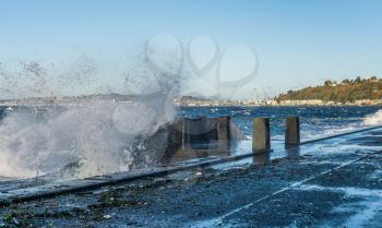 Waves crash on the waterfront at Alki Beach in West Seattle, Washington.
