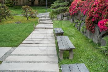 Benches sit by a walkway in Seattle, Washington.