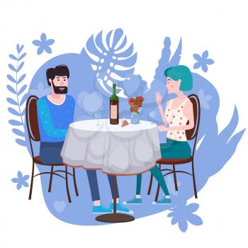 Loving couple is drinking vine in cafe. A man and a woman in love on date are sitting at a table