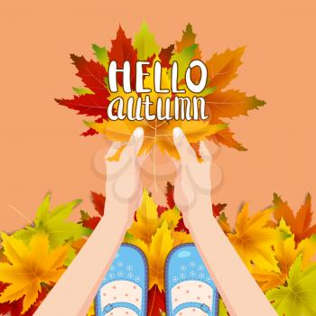 Women blue shoes on autumn leaves. Hands holding autumn leaves. Lettering Hello Autumn