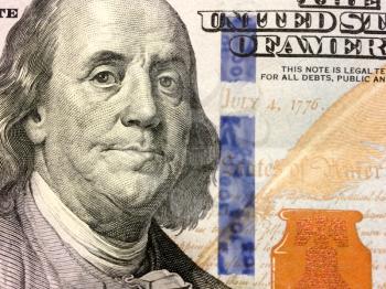 July 4 1776 text on 100 dollar bill close up in gold color