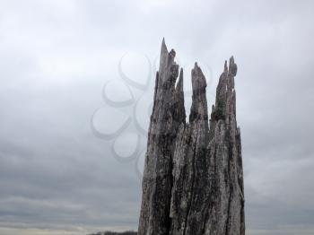 Creepy scary old wood under gray cloudy ominous sky background