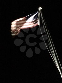 American flag on flagpole motion background black at night with spotlight